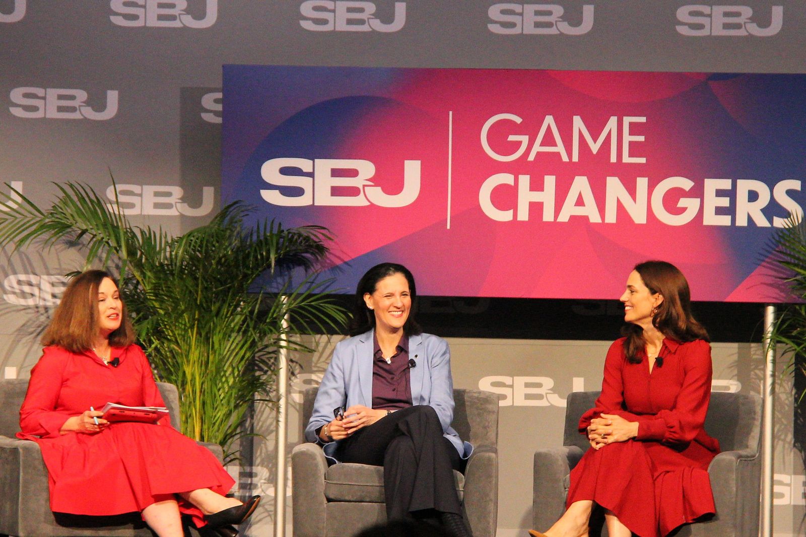 Three women seated on the Game Changers stage during the Bridging the Gap session
