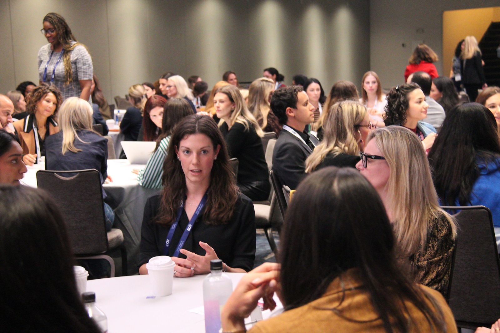 Attendees listen as one speaks at a crowded table
