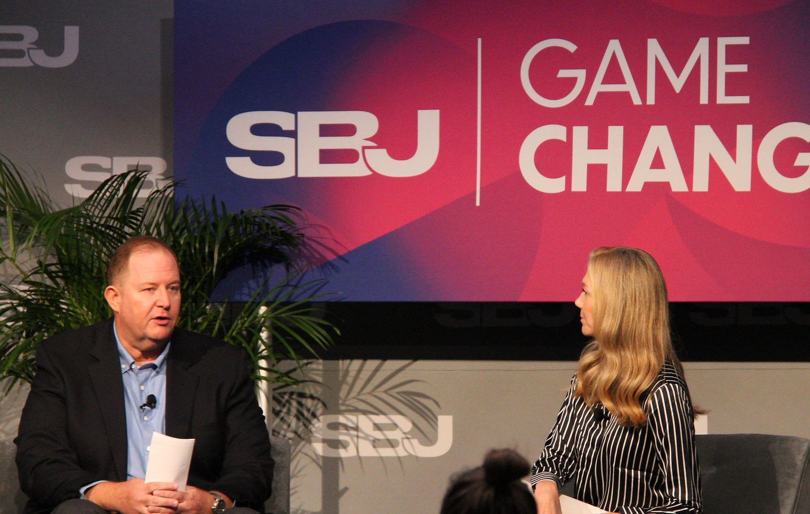 Rob Johnston speaks while Monica Fee listens on stage
