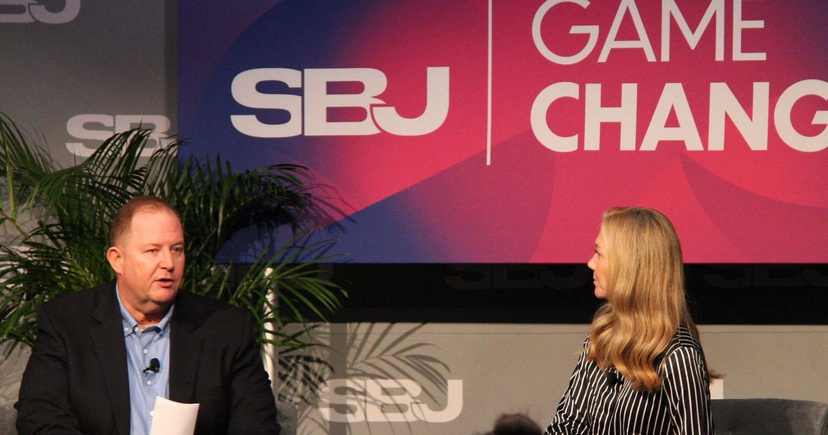 Rob Johnston speaks while Monica Fee listens on stage
