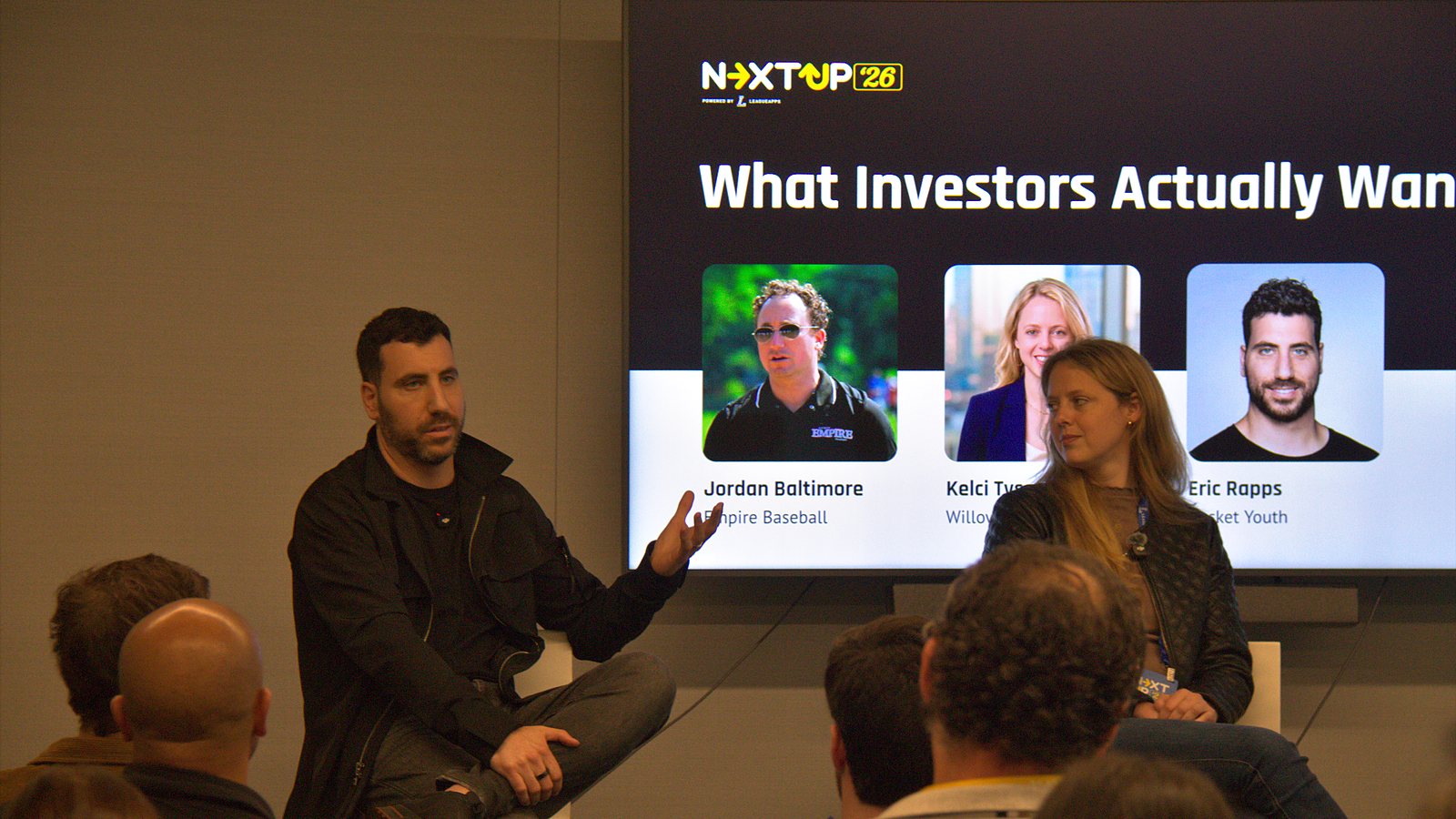Eric Rapps gestures while speaking, seated beside Kelci Tyson
